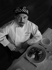 Photo of Nicholas Petti holding a plate of turkey (black and white)